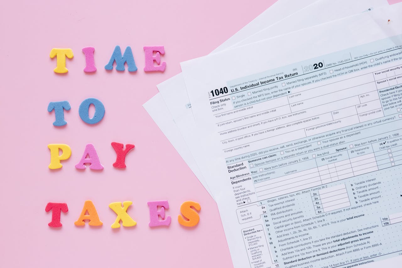 1040 tax forms with colorful Time to Pay Taxes letters.